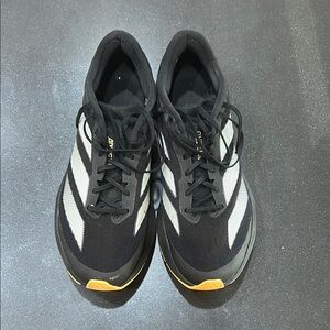 Black and White Athletic running Shoes with Yellow Accents. hardly worn